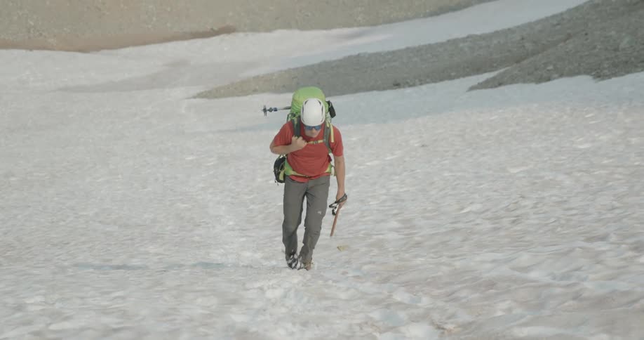 A man is hiking outdoors during the day