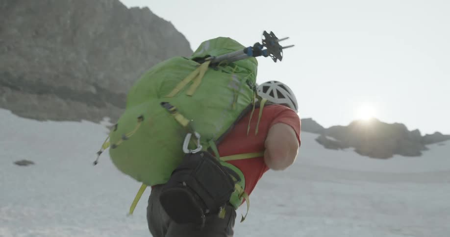 A man hikes up the side of a mountain