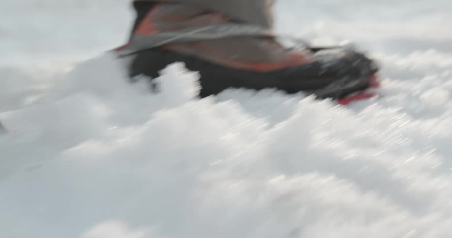 Man hiking up a snowy mountain