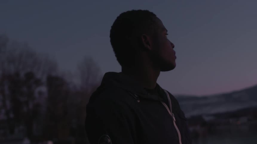 A man looking off into the distance at dusk