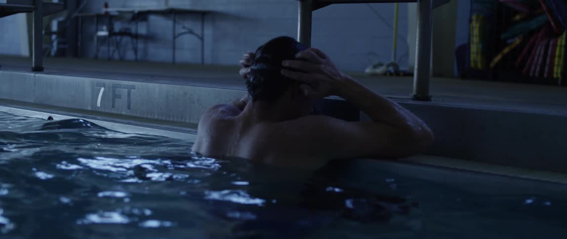 A man is swimming in a pool