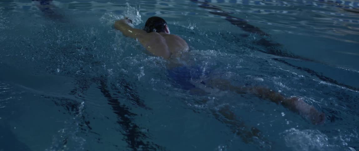 Man swimming in a pool doing laps
