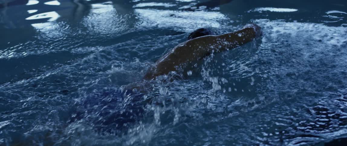 A man is swimming in a pool