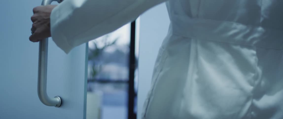 A doctor opening a lobby door