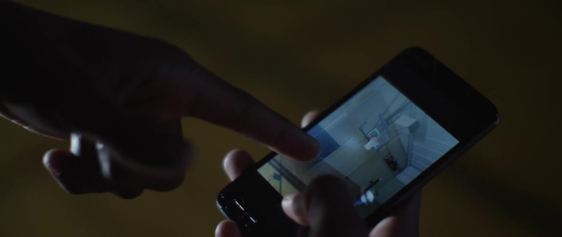 A person uses their fingers to scroll through pictures on a cell phone