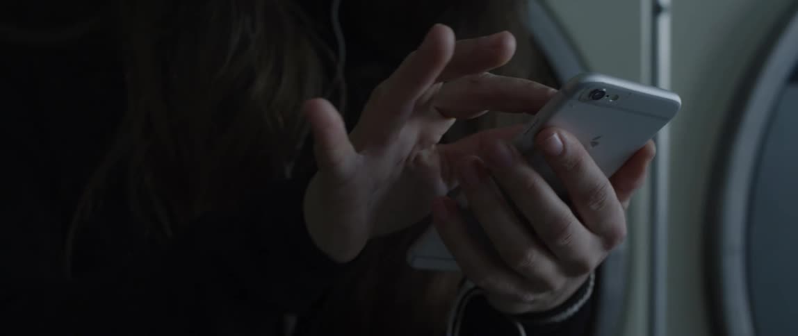 A woman scrolling on her cell phone