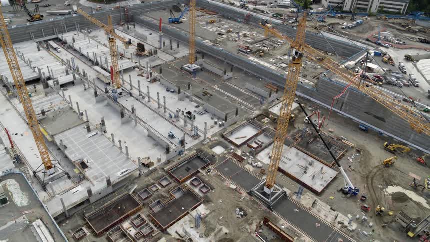 Traverse over a new concrete foundation for a large building project under construction
