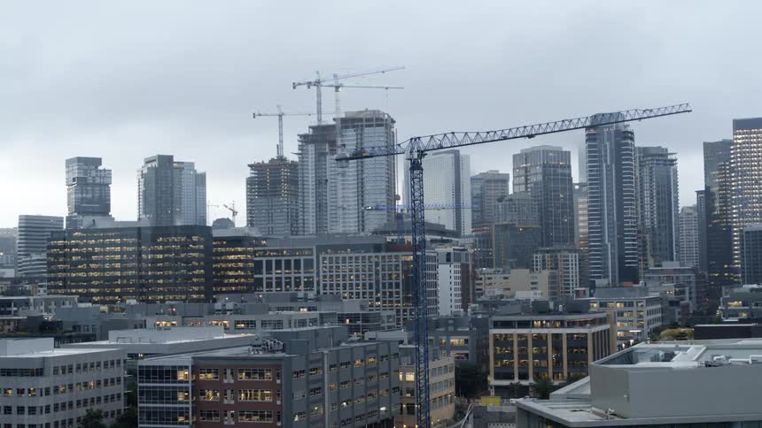 An aerial view of a downtown area in a city with multiple new buildings under construction