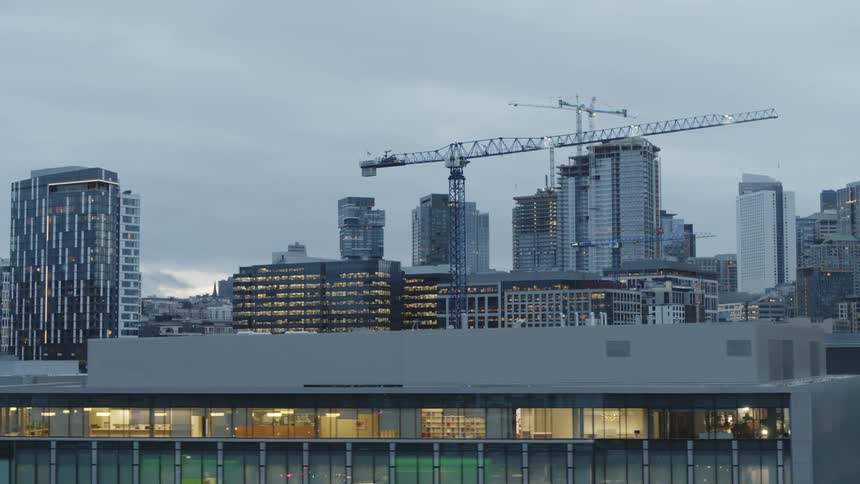 Rooftop traverse along a city skyline with multiple new buildings under construction