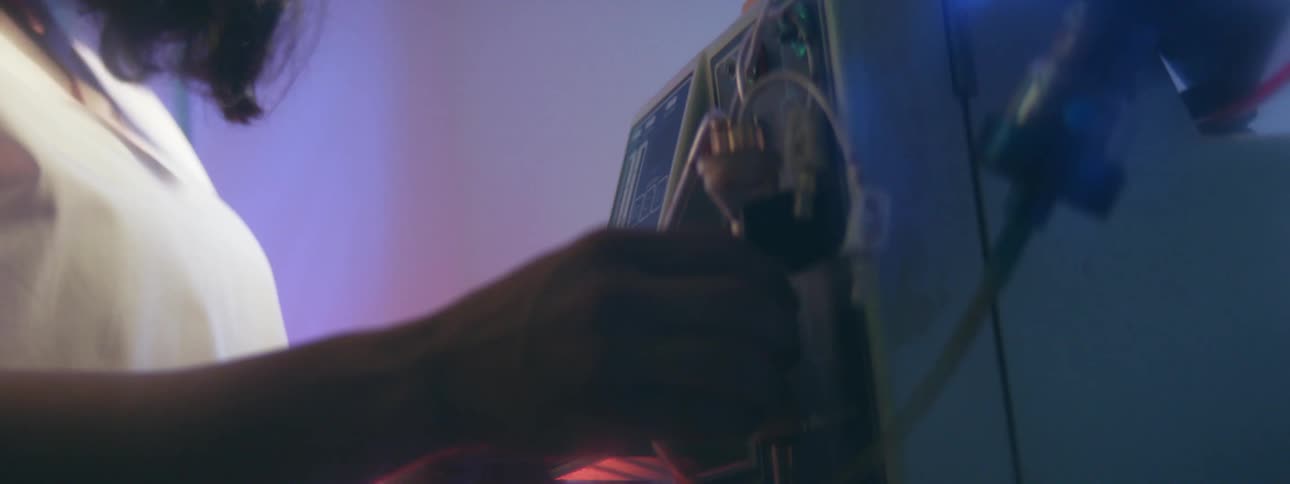 A nurse in a hospital adjusts medical equipment