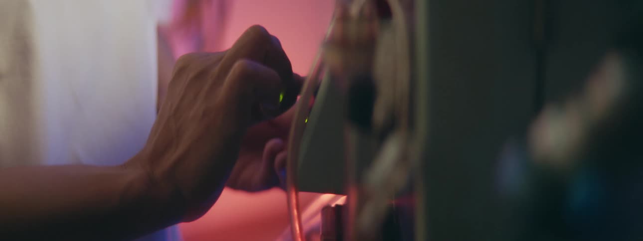 A nurse adjusts medical equipment