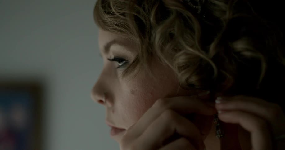 Woman putting on an earring