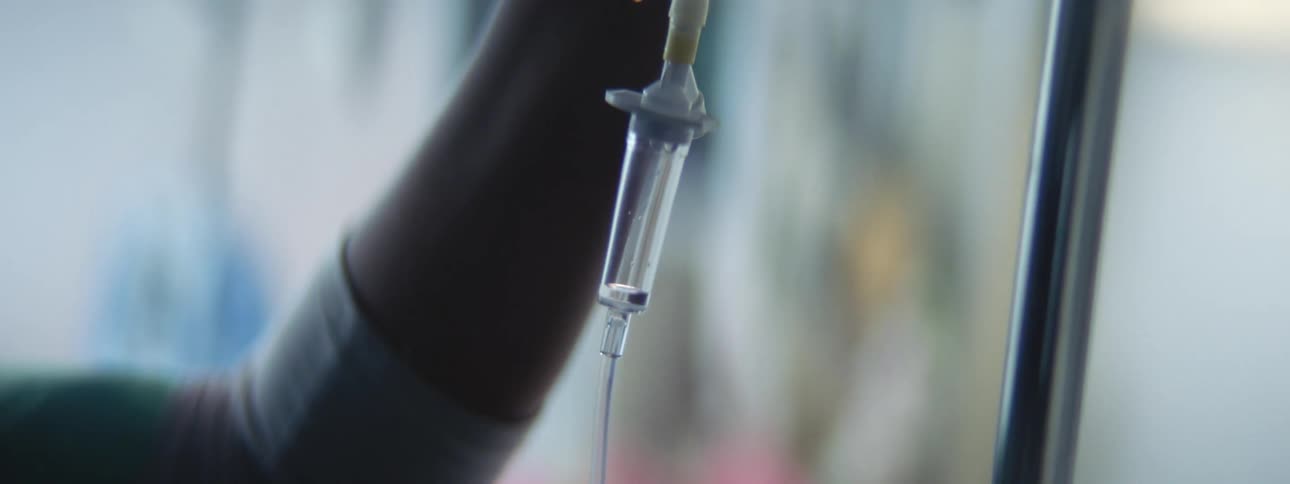 A nurse adjust an iv in a hospital