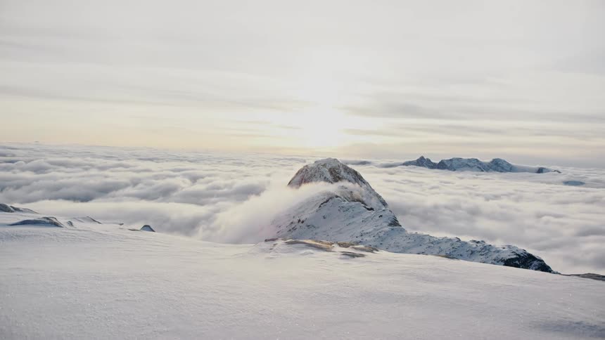 Clouds are surrounding the mountain at dusk