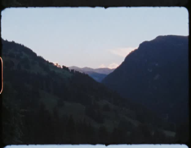 A mountain slope covered in vegetation during the day