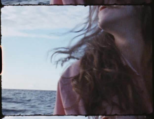Woman with her hair blowing in the wind traveling on a boat at daytime out in the ocean