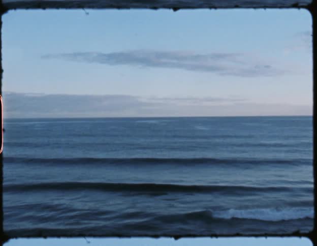 Ocean with waves and a few white clouds