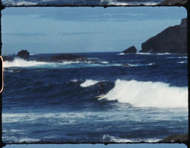 Man riding an ocean wave on a yellow surfboard in the ocean at daytime