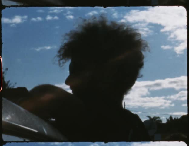 A man preparing a load on top of his car