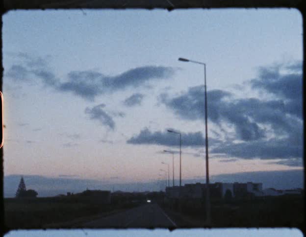 Cars travel on the road at sunset