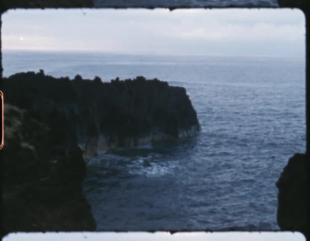 Waves crash onto the bottom of a cliff