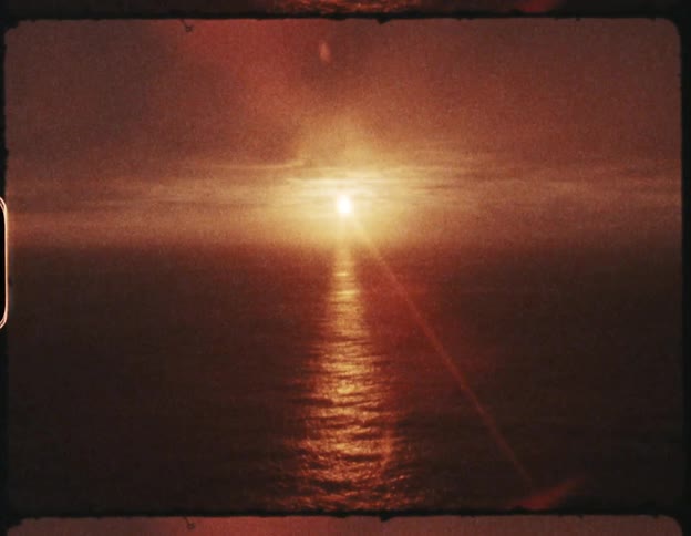 Film strip of the sun setting over the ocean