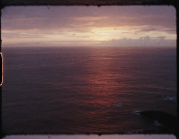 A film strip of the sun setting over the coast
