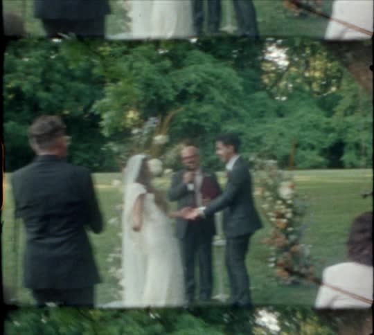 A newly wed bride and groom hold hands and dance at the alter