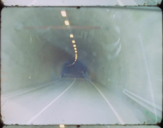 A film strip of a car driving in a tunnel