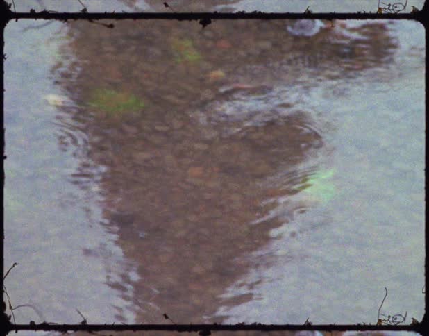 A vintage film of water rippling in a river
