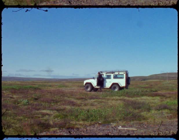 A shot of someone going into a land rover