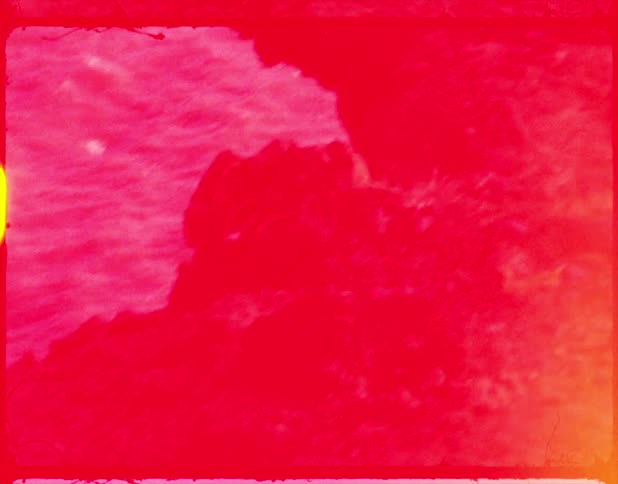 An old filmstrip of a cliff and water