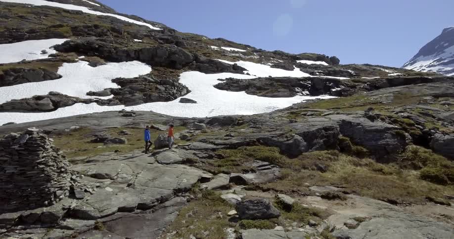 Two people are hiking on the top of a mountain