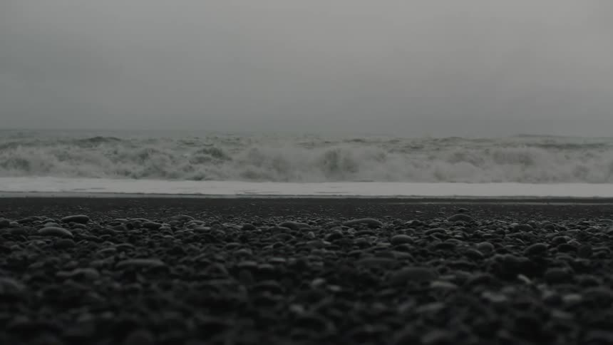 Strong waves crashing the shoreline on a stormy day