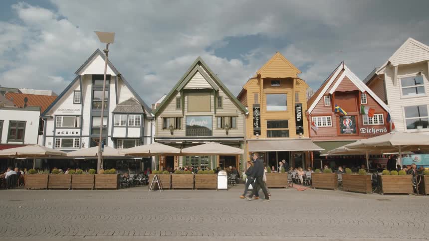 People walk by buildings in a town