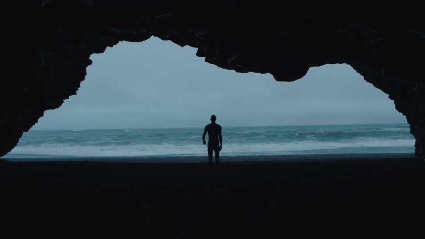 A man a walking at the beach during the day