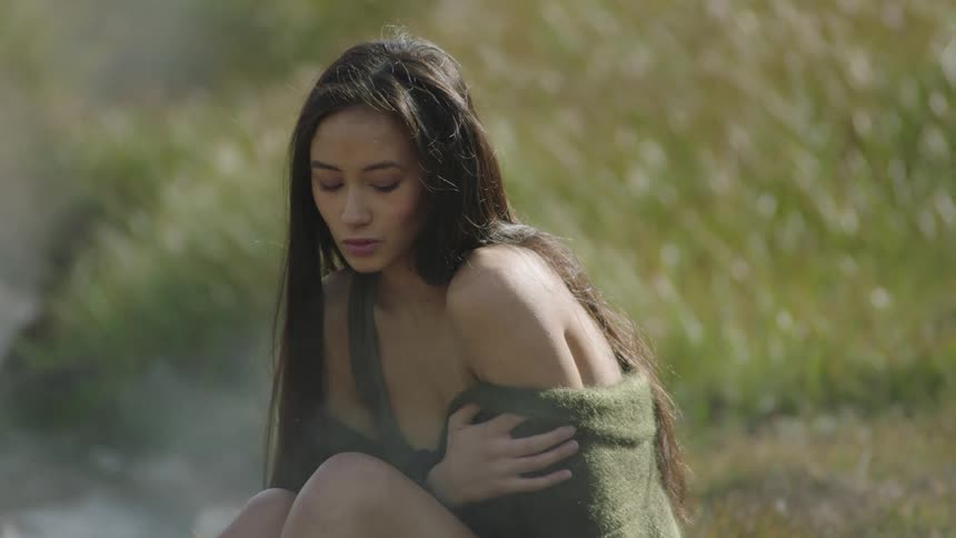 A woman sitting in a field
