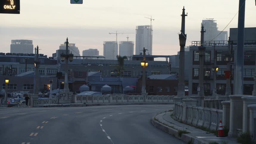 The road by the city is empty at sunrise
