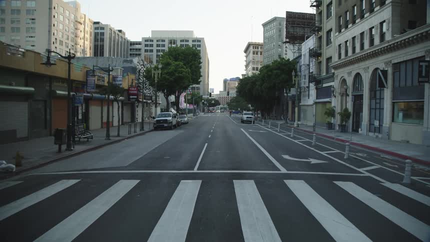Empty streets are revealed as a car drives through a city