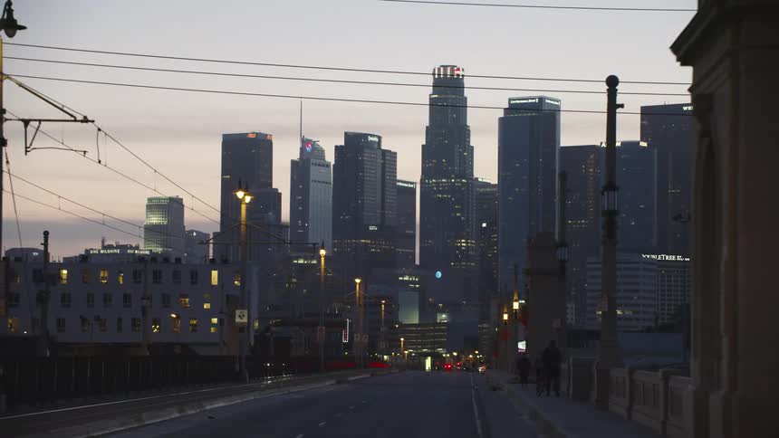 Traveling on a bridge towards a big city area in the evening