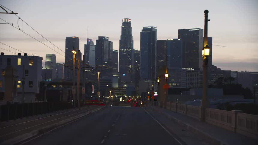 Downtown city skyline at sunset from a bridge entering the city