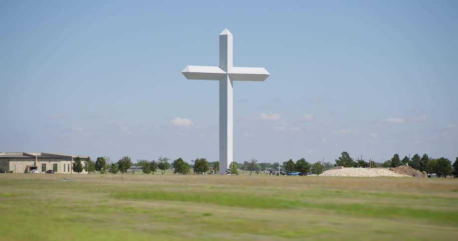 Driving by a large crucifixstructure on a field
