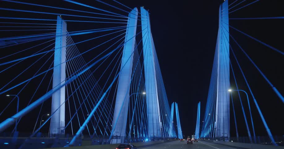 Cars driving across a large bridge