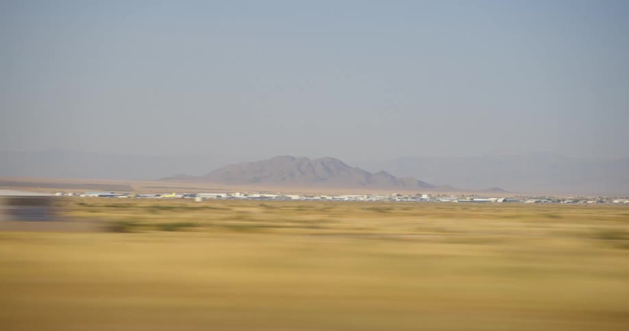 Time lapse of a field with buildings in the distance