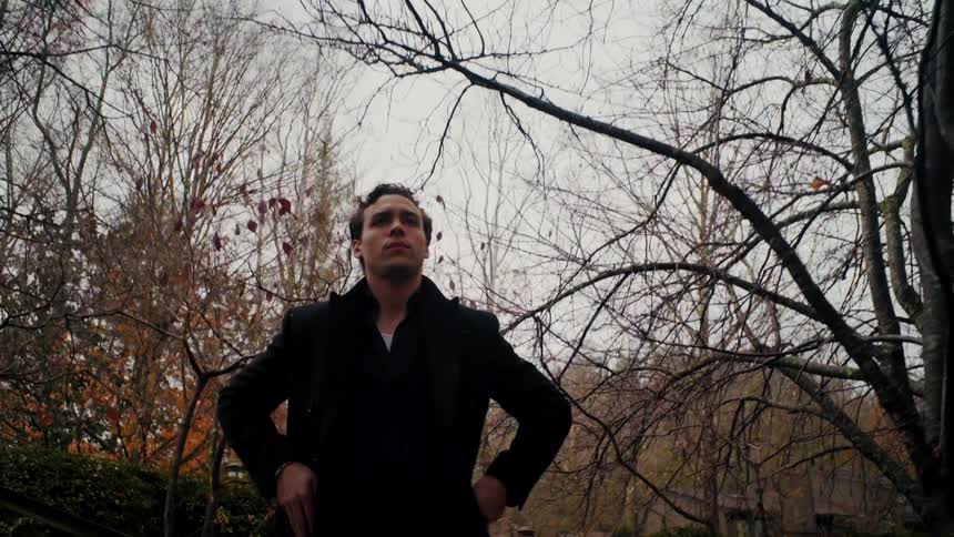 A man is walking outdoors in autumn