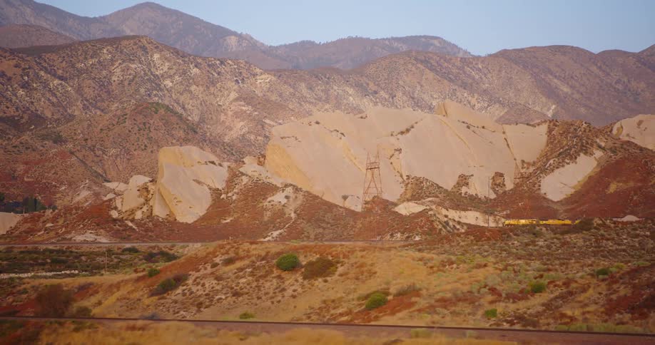 A wide shot of a dark red hillside