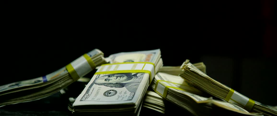 Wrapped counted money stacked in a pile
