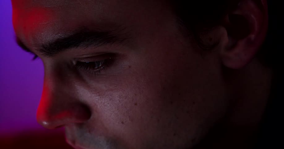 A young man focuses intensely on his task that he is working on