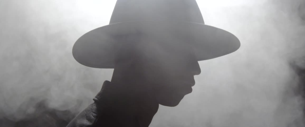 A young man standing in the fog