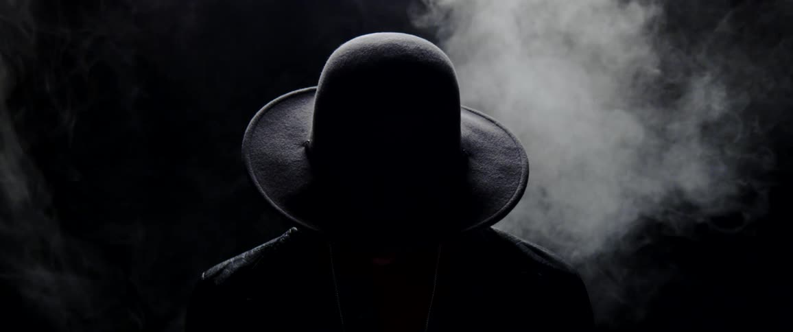 A person sitting behind a cloud of smoke